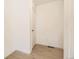 Bright hallway with light wood floors and fresh white walls at 718 N Clubview St, Watkins, CO 80137