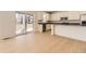Contemporary kitchen featuring stainless steel appliances, white cabinets, a center island and sliding door to the backyard at 718 N Clubview St, Watkins, CO 80137