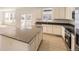 Beautiful kitchen featuring a center island, modern appliances, granite countertops, and hardwood flooring at 718 N Clubview St, Watkins, CO 80137