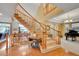 Elegant wooden staircase with a curved design and wooden railing at 5508 Triple Crown Dr, Frederick, CO 80504