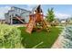 Large backyard features wooden playset and backyard access from elevated deck at 9406 Bross St, Arvada, CO 80007