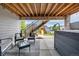 Relaxing backyard under deck features outdoor seating, hot tub and backyard play area at 9406 Bross St, Arvada, CO 80007