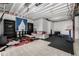 Large partially finished basement featuring a living room, play area, and ample storage at 9406 Bross St, Arvada, CO 80007