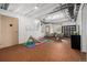 Partially finished basement featuring recreational area, wood flooring, and exposed ceiling at 9406 Bross St, Arvada, CO 80007