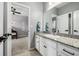 Well-lit bathroom with granite countertops and white cabinetry, connecting to the bedroom at 9406 Bross St, Arvada, CO 80007