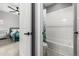 Hall bath including white tiled walls and tub shower combo, plus neutral flooring at 9406 Bross St, Arvada, CO 80007
