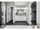 Elegant bathroom with double vanity, modern fixtures, and black tiled floor at 9406 Bross St, Arvada, CO 80007