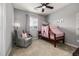 Cozy bedroom with plush chair, pink accents, and a charming canopy bed at 9406 Bross St, Arvada, CO 80007