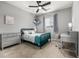 Comfortable bedroom with carpet, ceiling fan, and a desk area, perfect for studying at 9406 Bross St, Arvada, CO 80007