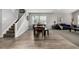 Bright dining area, features hardwood floors, a staircase, and a view into the living room at 9406 Bross St, Arvada, CO 80007