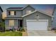 Charming two-story home featuring gray siding, a two-car garage, and a well-maintained front yard at 9406 Bross St, Arvada, CO 80007