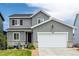 Charming two-story home featuring gray siding, a two-car garage, and a well-maintained front yard at 9406 Bross St, Arvada, CO 80007