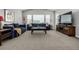 Spacious living room with high ceilings, large windows, comfortable blue sofas and stylish furniture at 9406 Bross St, Arvada, CO 80007