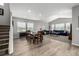 Open-concept living room with hardwood floors, a dining table, and comfortable blue couches at 9406 Bross St, Arvada, CO 80007