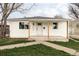 Exterior view of a cozy white home with new porch at 1405 Eaton St, Lakewood, CO 80214