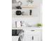 Bright kitchen features white cabinets, countertops, floating shelves, and modern decor at 1405 Eaton St, Lakewood, CO 80214