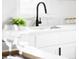 Modern kitchen sink with marble countertops and a garden window at 1405 Eaton St, Lakewood, CO 80214