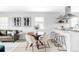Open living area featuring a dining table with chairs, a modern kitchen, and a comfortable couch at 1405 Eaton St, Lakewood, CO 80214
