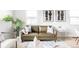 Cozy living room with an olive colored couch and modern decor at 1405 Eaton St, Lakewood, CO 80214