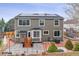 The back of a gray house with solar panels, a deck, and a patio at 5370 S Flanders Way, Centennial, CO 80015