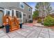 A gray house with a wooden deck and a stone patio in the backyard at 5370 S Flanders Way, Centennial, CO 80015