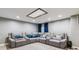 Finished basement with a large grey sectional and blue accent pillows at 5370 S Flanders Way, Centennial, CO 80015
