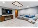 Finished basement with a large sectional and entertainment center with a fireplace at 5370 S Flanders Way, Centennial, CO 80015