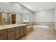 A large Primary bath features a soaking tub, double sinks, and access to a shower at 5370 S Flanders Way, Centennial, CO 80015