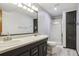 A grey bathroom has a shower and a dual sink vanity at 5370 S Flanders Way, Centennial, CO 80015