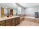 Bathroom showcasing double sinks, a bathtub with a tile surround, and a separate shower at 5370 S Flanders Way, Centennial, CO 80015
