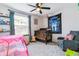 Bedroom with natural light, crib, toys, and comfortable rocking chair at 5370 S Flanders Way, Centennial, CO 80015