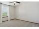 An empty carpeted bedroom features a ceiling fan and window with white drapes at 5370 S Flanders Way, Centennial, CO 80015