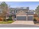 Inviting two-story home featuring a three-car garage, stone accents, solar panels, and well-maintained landscaping at 5370 S Flanders Way, Centennial, CO 80015