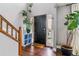 Inviting foyer featuring hardwood floors, a black front door, and stylish decor, creating a warm welcome at 5370 S Flanders Way, Centennial, CO 80015