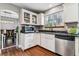 Well-maintained kitchen featuring white cabinets and stainless steel appliances, providing a functional cooking space at 5370 S Flanders Way, Centennial, CO 80015