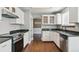 Well-equipped kitchen with stainless steel appliances, granite countertops, and ample cabinet space at 5370 S Flanders Way, Centennial, CO 80015