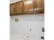 A laundry room features overhead cabinets and new vinyl floors at 5370 S Flanders Way, Centennial, CO 80015