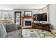 Inviting living room featuring a fireplace, TV, and a cozy couch on top of stylish patterned rug at 5370 S Flanders Way, Centennial, CO 80015