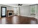 Spacious living room with hardwood floors, fireplace, ceiling fan and natural light from large windows at 5370 S Flanders Way, Centennial, CO 80015