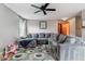 Comfortable living room featuring a large sectional sofa and colorful patterned rug at 5370 S Flanders Way, Centennial, CO 80015