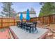 Outdoor patio with two blue umbrellas, wood fence and an outdoor dining set at 5370 S Flanders Way, Centennial, CO 80015