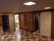 Finished basement area featuring unique flooring, wood paneling, and a barn door at 5370 W Arizona Pl, Lakewood, CO 80232