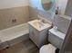 Compact bathroom featuring a bathtub with tile surround and a single vanity sink at 5370 W Arizona Pl, Lakewood, CO 80232