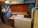 A laundry room with a washer, dryer, cabinets, and laminate countertops at 5370 W Arizona Pl, Lakewood, CO 80232