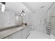 Modern bathroom features white cabinets, grey countertops, and white tile floors with a shower and tub at 1750 Wewatta St # 1301, Denver, CO 80202