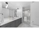 Modern bathroom with double vanity, a large mirror, and a glass-enclosed shower for a spa-like feel at 1750 Wewatta St # 1301, Denver, CO 80202