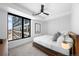 Bedroom with large windows offering city views and stylish ceiling fan above a platform bed at 1750 Wewatta St # 1301, Denver, CO 80202