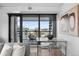 Dining area with modern table, transparent chairs, and sliding glass doors to the outdoor terrace at 1750 Wewatta St # 1301, Denver, CO 80202