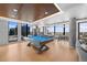 Well-lit game room with pool table, foosball table, and city views at 1750 Wewatta St # 1301, Denver, CO 80202