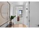 Bright hallway with wood floors, accent art and a view of the desk and window in the next room at 1750 Wewatta St # 1301, Denver, CO 80202